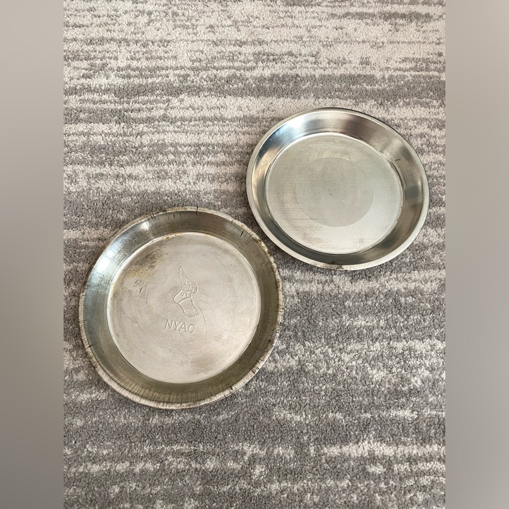 2 large vintage pie tins 11”, 1 NYAC winged foot and 1 blank